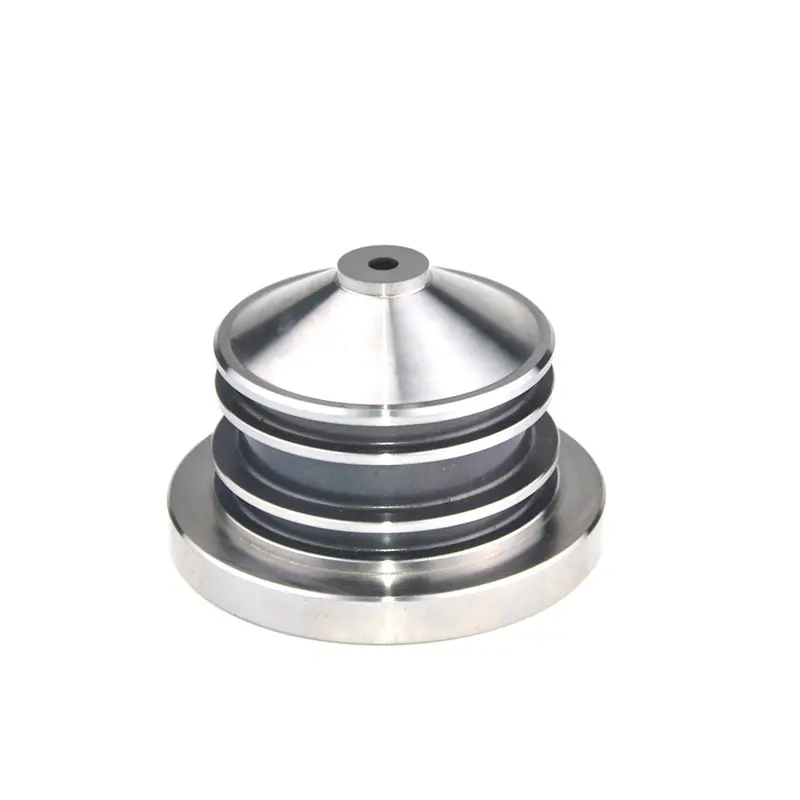 Round precision machined metal component with a conical top, central hole and stepped 